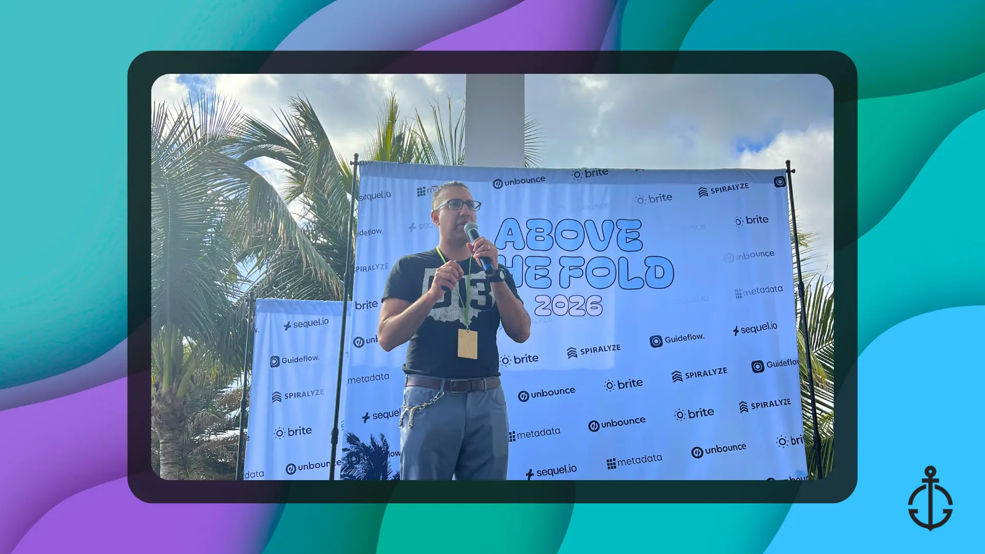 Above the Fold 2026 event — speaker presenting on stage with sponsor backdrop